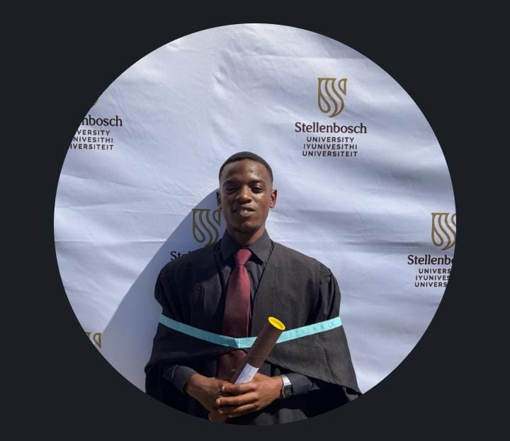 Mayibongwe Mpofu holding a graduation scroll at a Stellenbosch University ceremony